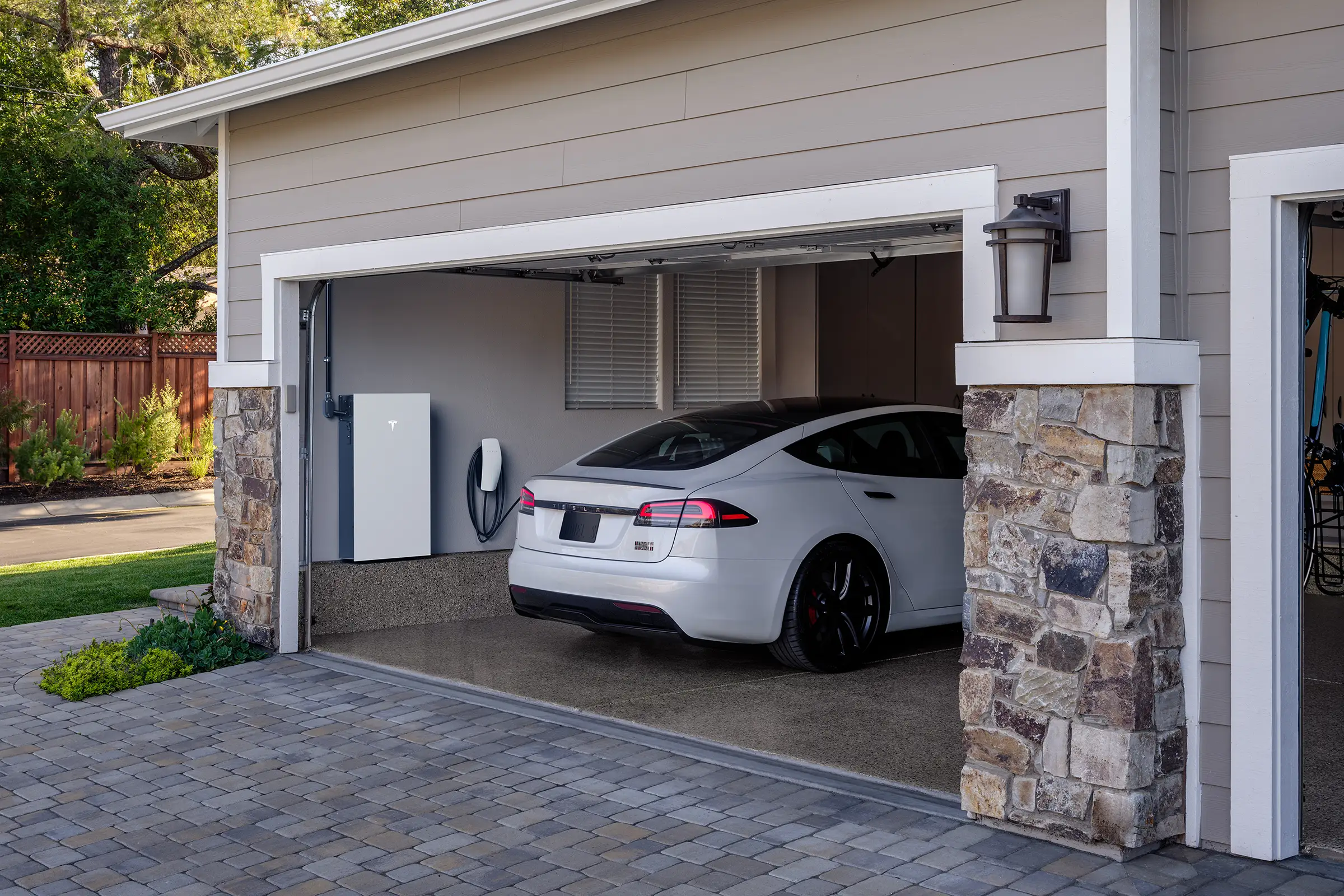 Tesla charging in home garage with wall connector and powerwall system installed in Houston TX
